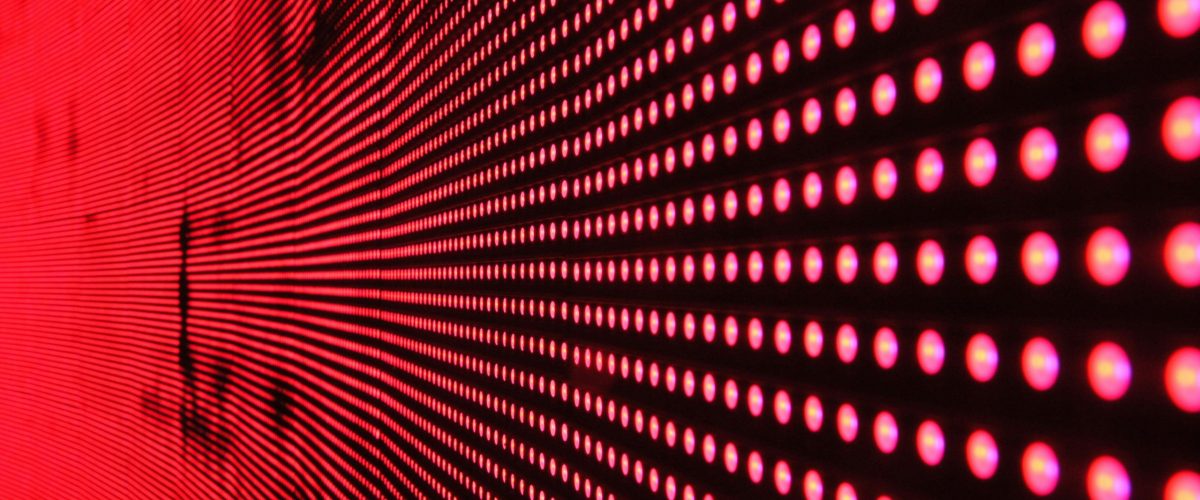 Vibrant abstract pattern of illuminated red LED lights forming a dynamic design.